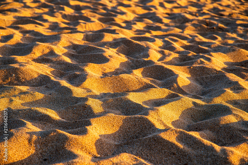 Golden sand texture at sunset, beach vacation and travel background