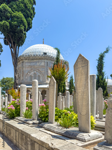 Photography Stone tombstones in a historical cemetery with a domed mausoleum and lush greene