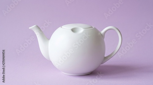 A round white ceramic teapot with a sleek spout and lid, centered against a pastel purple background for a clean, modern look.