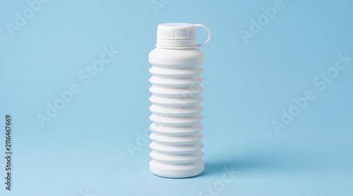 White collapsible silicone water bottle with expandable accordion design and screw cap, isolated on a light blue background.