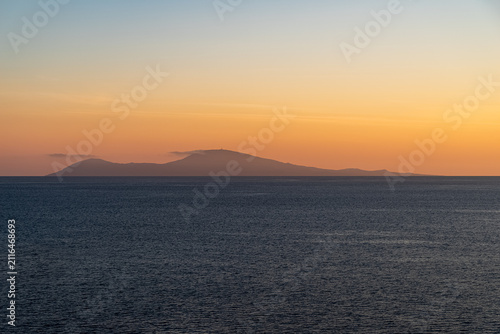 Tranquil ocean sunset with distant islands, nature's beauty and peaceful horizon