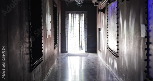 Dark mysterious hallway leading to bright light window