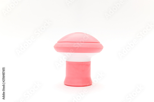 A pink rubber facial exerciser for improving tone. On a white background.