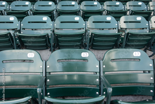 High-resolution photograph of empty seating at a professional baseball stadium with the baseball field visible in the background. 