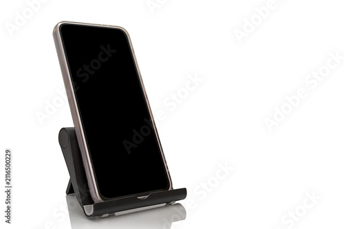 A phone stand with a phone. Reflected on a white background. For comfort and safety.