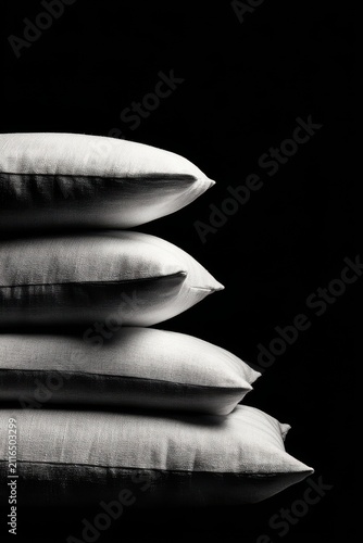 Stacked Pillows in Studio Setting on Black Background Close Up Vertical Composition for Comfort and Design