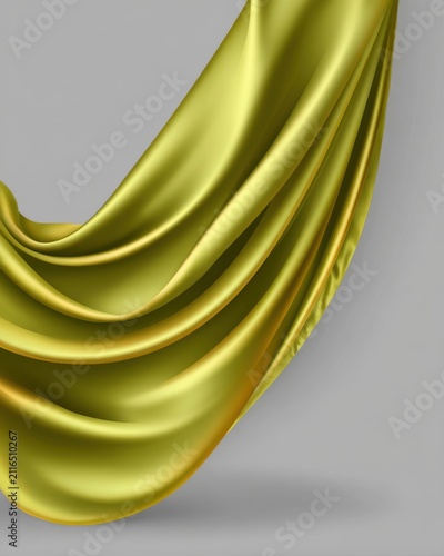 Golden fabric drapes elegantly against a neutral background studio shot showcasing luxurious texture and smooth folds for design element