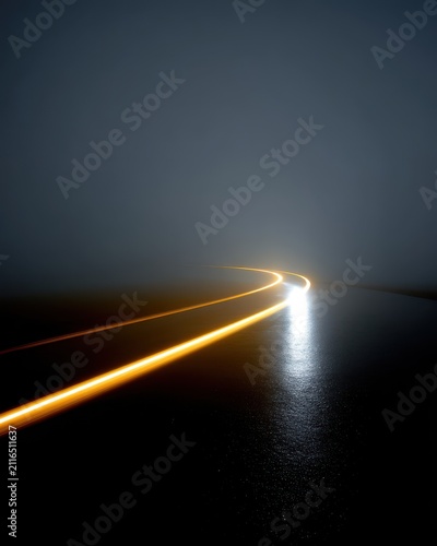 Car light trails on wet road at night in fog long exposure abstract low angle view transportation
