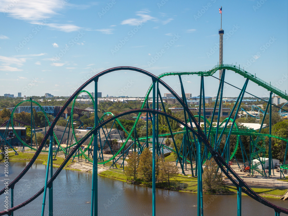 Fototapeta premium Orlando attraction park showcases roller coasters and festive atmosphere in sunny Florida. Popular tourist destination delivers joy, thrills and recreation.