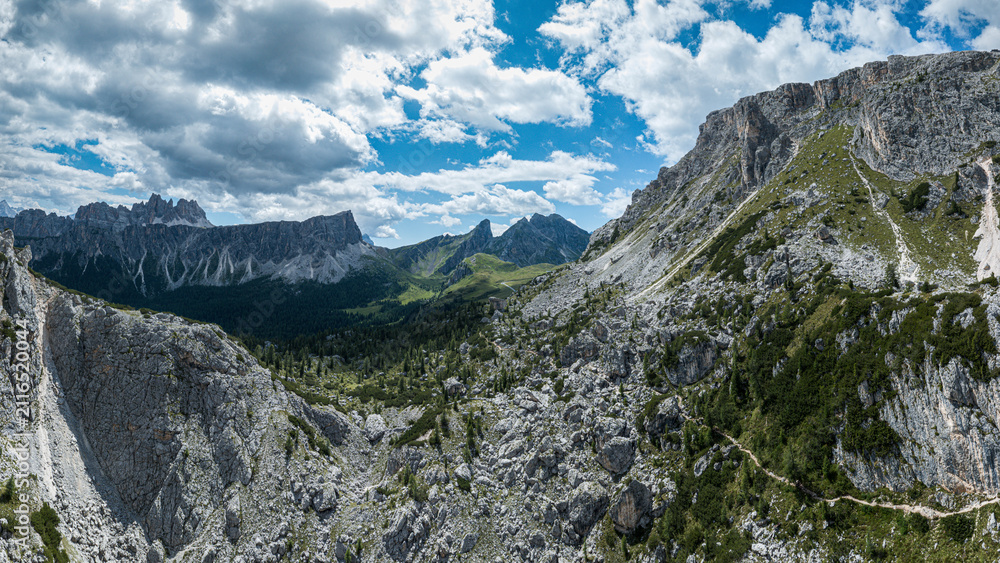 Obraz premium Dramatic mountain landscape on the Marmolada in the Italian Dolomites with rugged limestone cliffs, swirling clouds, and breathtaking alpine views from the summit.