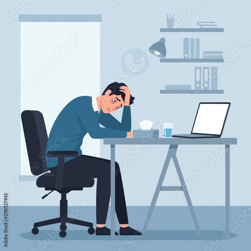 Depressed Man Experiencing Burnout Sitting At His Desk And Holding His Head In His Hands With A