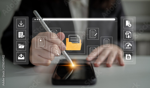 Fotografie Business Professional Using Digital Device to Organize and Edit Documents with Technology Interface and Data Graphics in a Modern Workspace