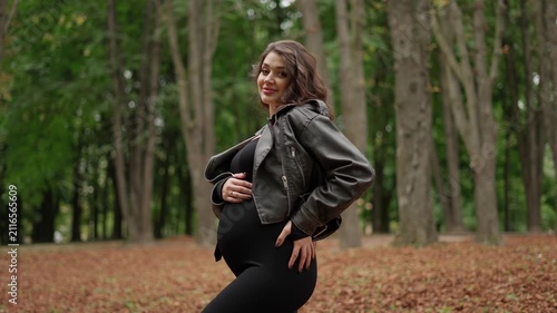 Pregnant woman in walking in the park. Pregnant woman concept.