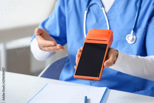 Male doctor with payment te...