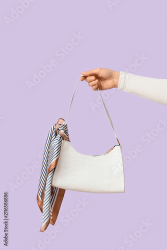 Female hand holding a white...