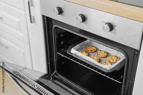 Open oven with baked cookie...