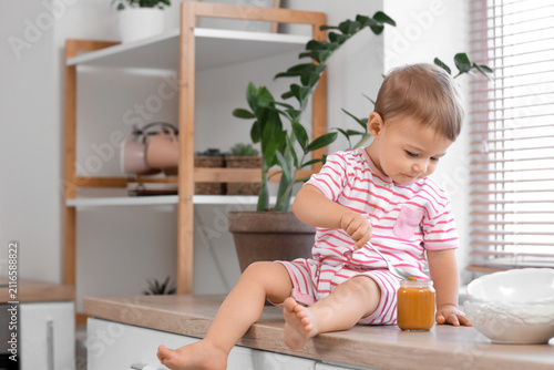 Cute little baby with jar o...