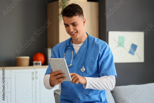 Male medical student using tablet at home