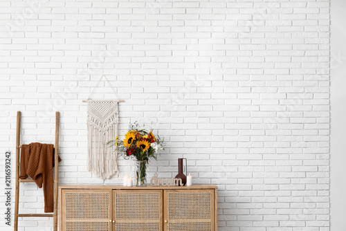 Wooden cabinet with bouquet...