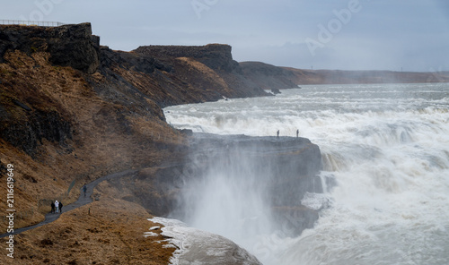 Cuadro en lienzo Gullfoss waterfall showing tourists observing the powerful cascading water of th