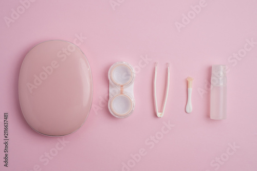Obraz na plátně Contact lenses accessories kit aligned in a row on pink background