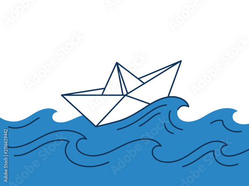 Paper boat floating on blue waves