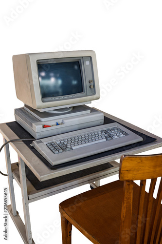 Vintage desktop computer setup from the 1980s with CRT monitor, mechanical keyboard, horizontal case, and wooden chair isolated on a white background.