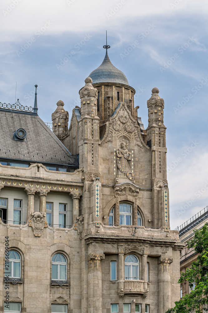 Fototapeta premium Corner turret and decorative stonework on the Art Nouveau facade of Gresham Palace in Budapest, Hungary