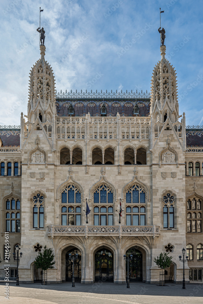 Fototapeta premium Gothic Revival facade of the former Ministry of Interior with twin spired towers and knight statues in Budapest, Hungary