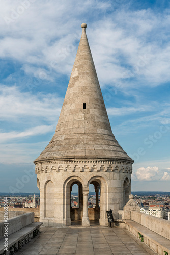 Conical stone turret of the Fisherman's Bastion overlooking the Budapest skyline and clouds, Hungary