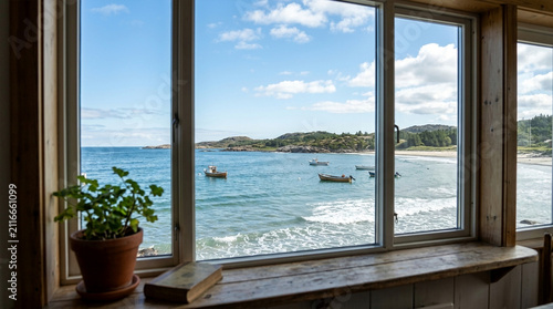 Coastal view through window, boats on sea, sunny day, green plant, book