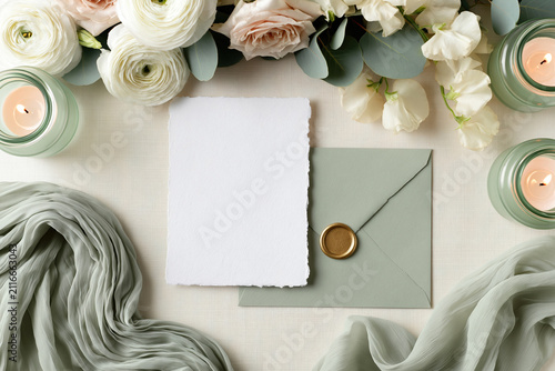 Blank white wedding invitation card mockup paired with a sage green envelope and wax seal