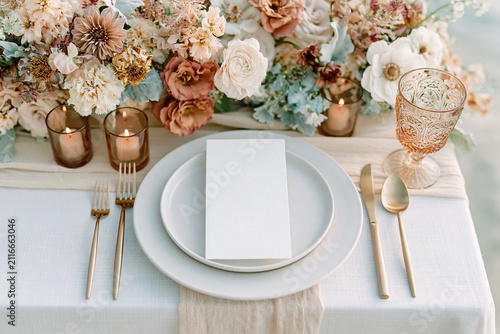 Elegant wedding menu card displayed on a formal place setting with refined tableware