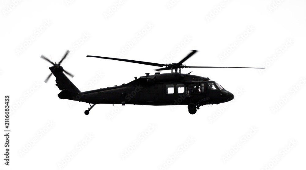 Fototapeta premium Silhouette of a Black Military Helicopter in Flight.