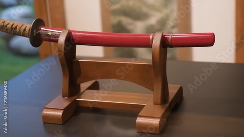 Traditional japanese katana short sword displayed on wooden stand