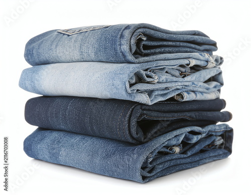 Neatly Folded Pile of Blue Denim Jeans in Different Washes from Light to Dark Blue on a White Backdrop