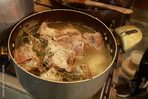 Pork pieces simmering before traditional Peruvian chicharrón preparation