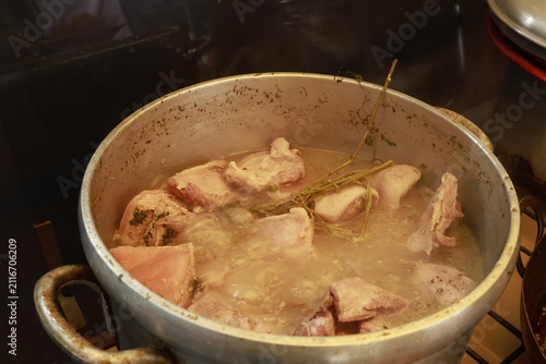 Pork pieces simmering before traditional Peruvian chicharrón preparation