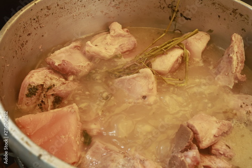 Pork pieces simmering before traditional Peruvian chicharrón preparation
