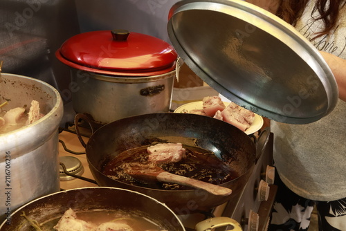 Pork meat cooking in hot lard for traditional Peruvian chicharrón