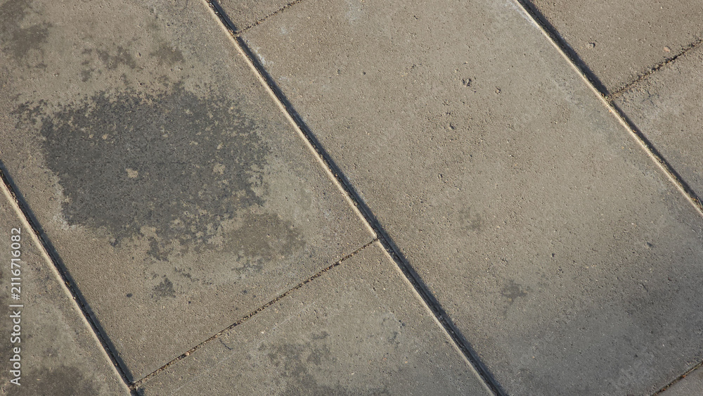 Fototapeta premium Detailed concrete pavement surface with square slabs, seams and natural texture suitable for architectural and design backgrounds