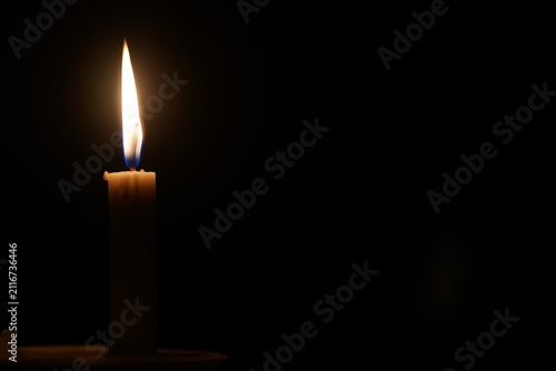 фотографія Single Burning Candle Flame in the Dark with Copy Space