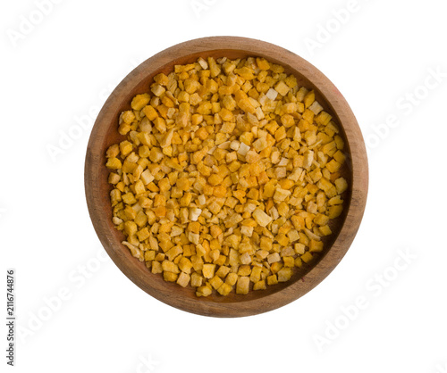  Freeze-dried mango pieces in a bowl on a white background