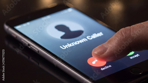 Obraz na płótnie Finger pressing decline button during unknown phone call on smartphone screen