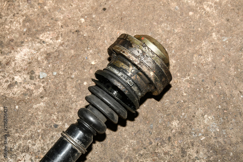 This component is a vehicle driveshaft or CV axle, commonly found on front-wheel drive and some all-wheel drive cars. Damage to this boot typically leads to grease leakage and joint failure
