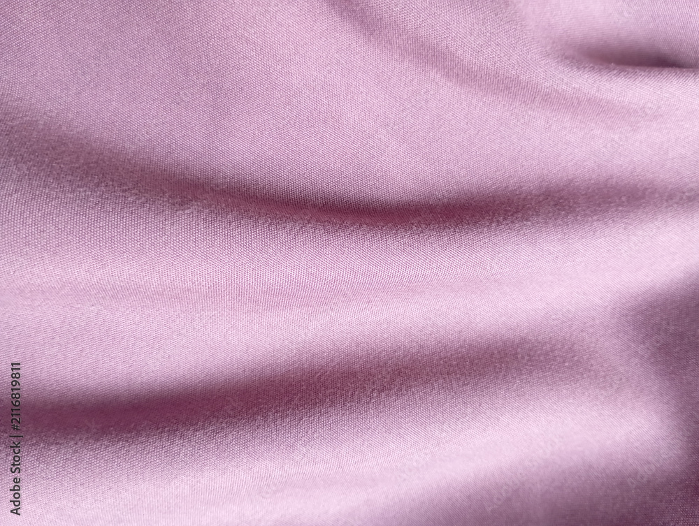 Fototapeta premium Soft pink cotton fabric texture with natural folds for design.