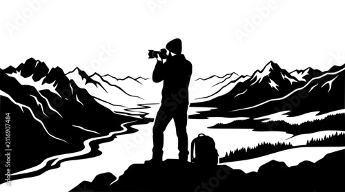 silhouette of a photographer taking a picture of a mountain landscape