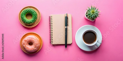 A delightful arrangement featuring a spiral notepad, pen, coffee, succulent plant, and two sweet treats on a vibrant pink background