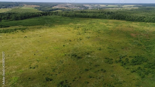 Smooth forward flight over grassy field