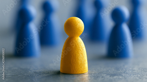 Glowing bright human figure standing uniquely out from dark blue crowded figures

